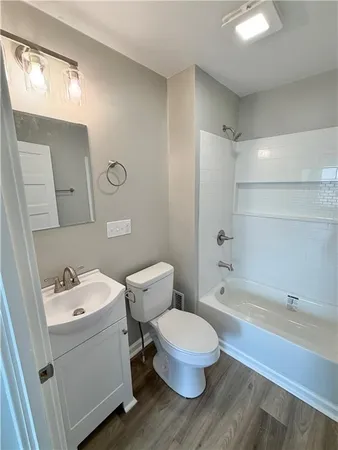 a bathroom with a sink toilet vanity and bathtub