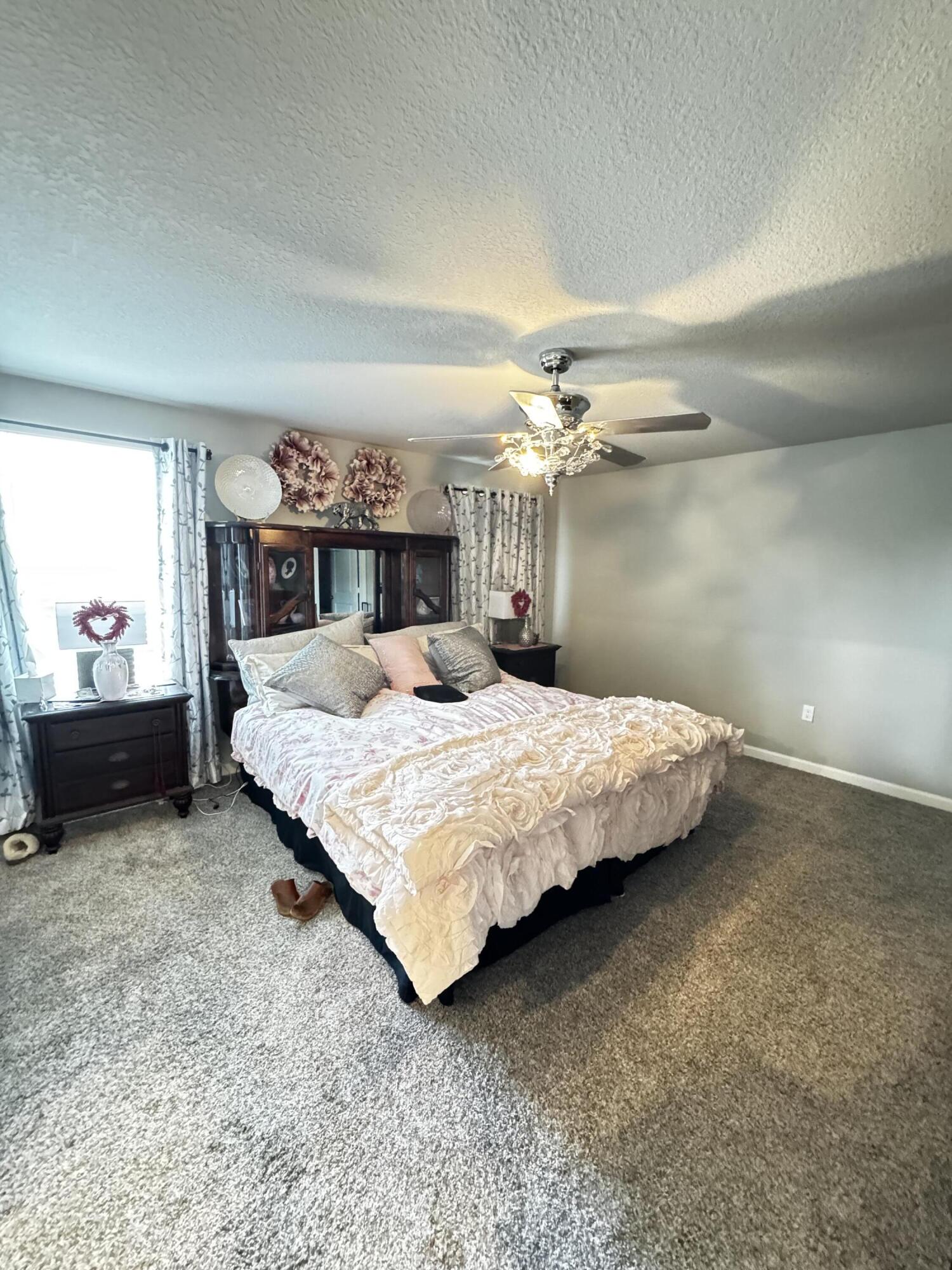 5646 Southeast Edgewater Circle Stuart, FL 34997 - Photo 12 of 20 a bedroom with a bed and window