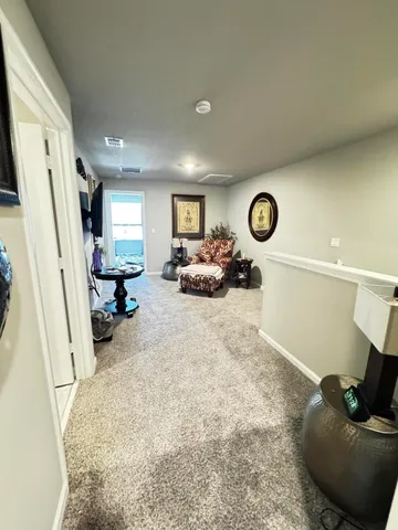 a bedroom with a bed and a flat tv screen on the dresser