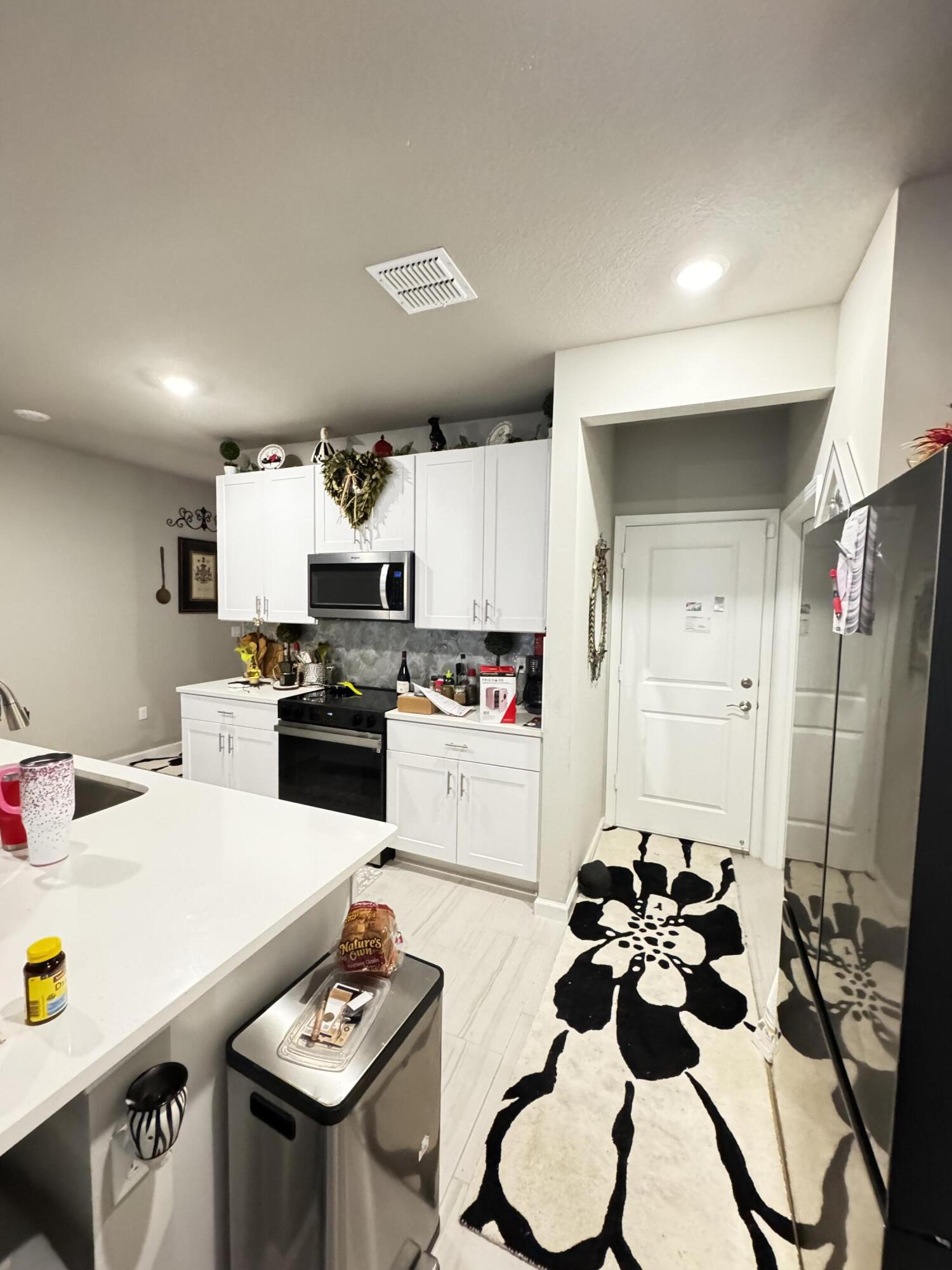5646 Southeast Edgewater Circle Stuart, FL 34997 - Photo 6 of 20 a kitchen with a sink stainless steel appliances and cabinets