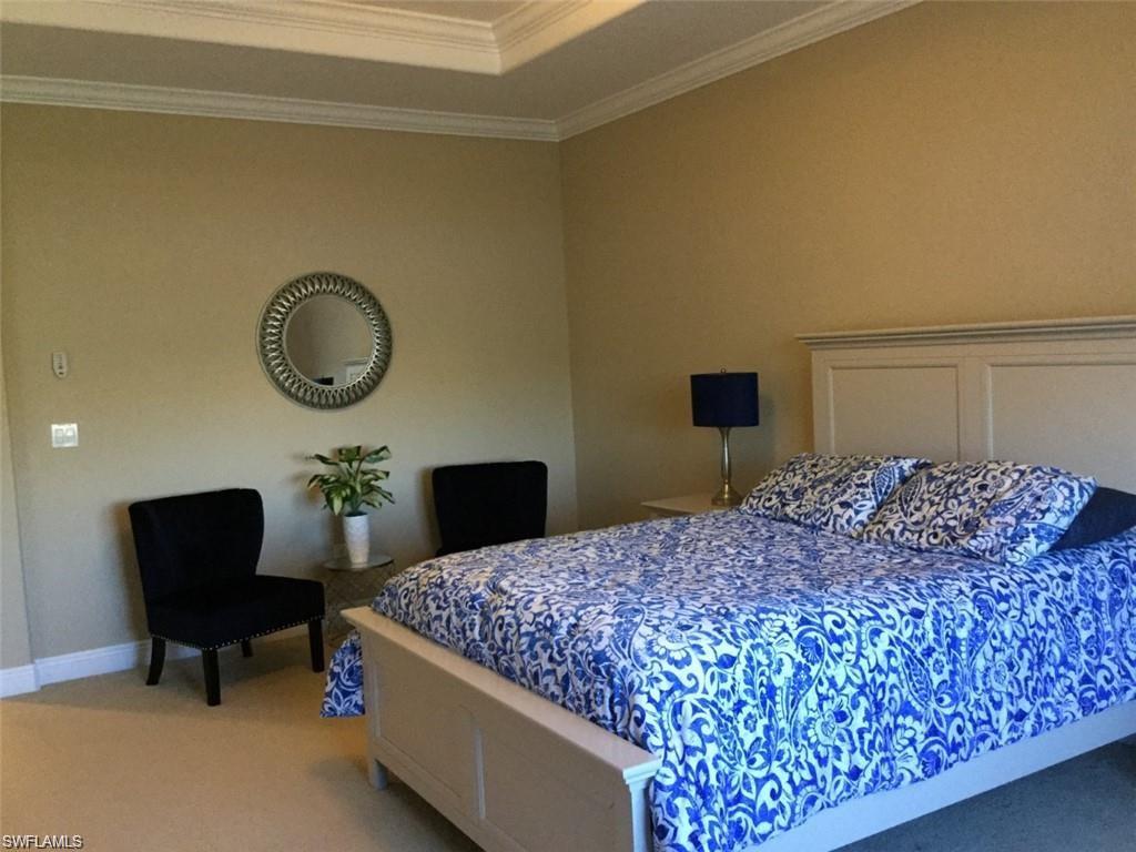 20085 Larino Loop Estero, FL 33928 - Photo 13 of 18 a bedroom with a bed and chair