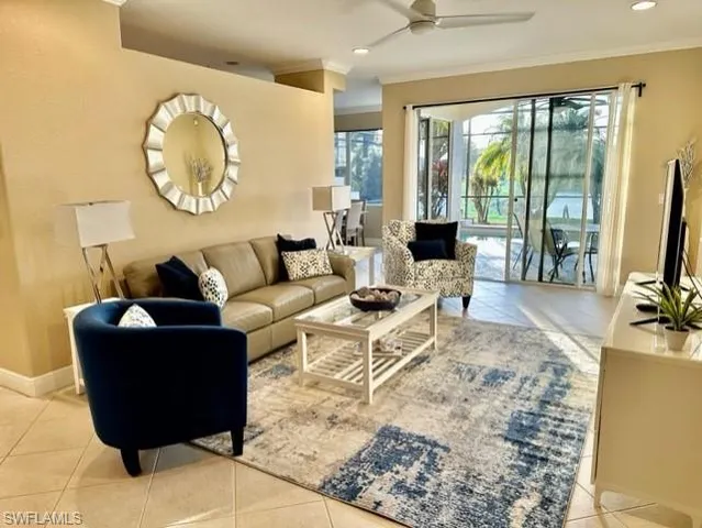 a living room with furniture a large window and a flat screen tv