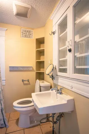 a bathroom with a sink a toilet and a window
