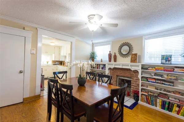 a view of a a dining room with furniture window and wooden floor
