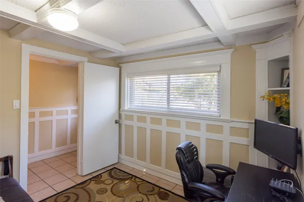 a view of a livingroom with workspace and a window