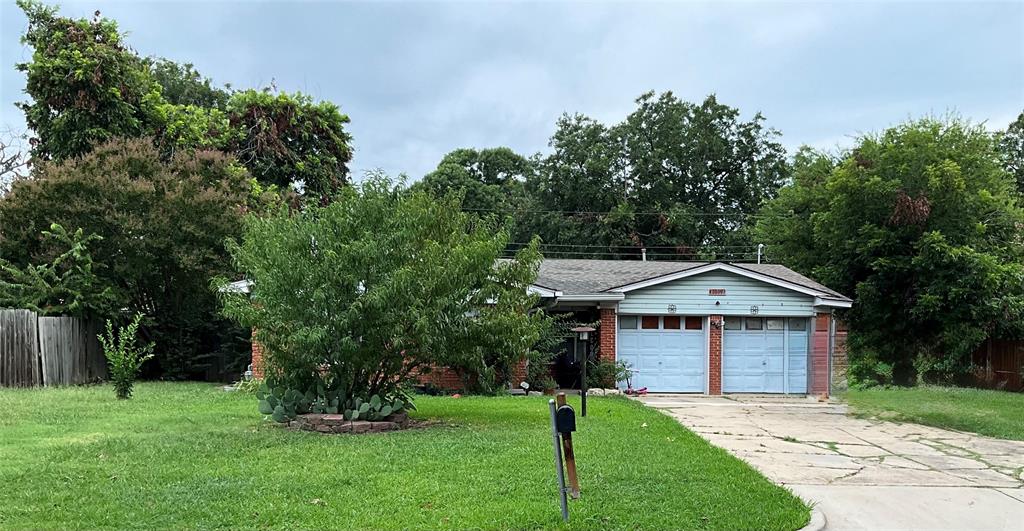 View of front facade featuring brick siding, a garage, and concrete driveway