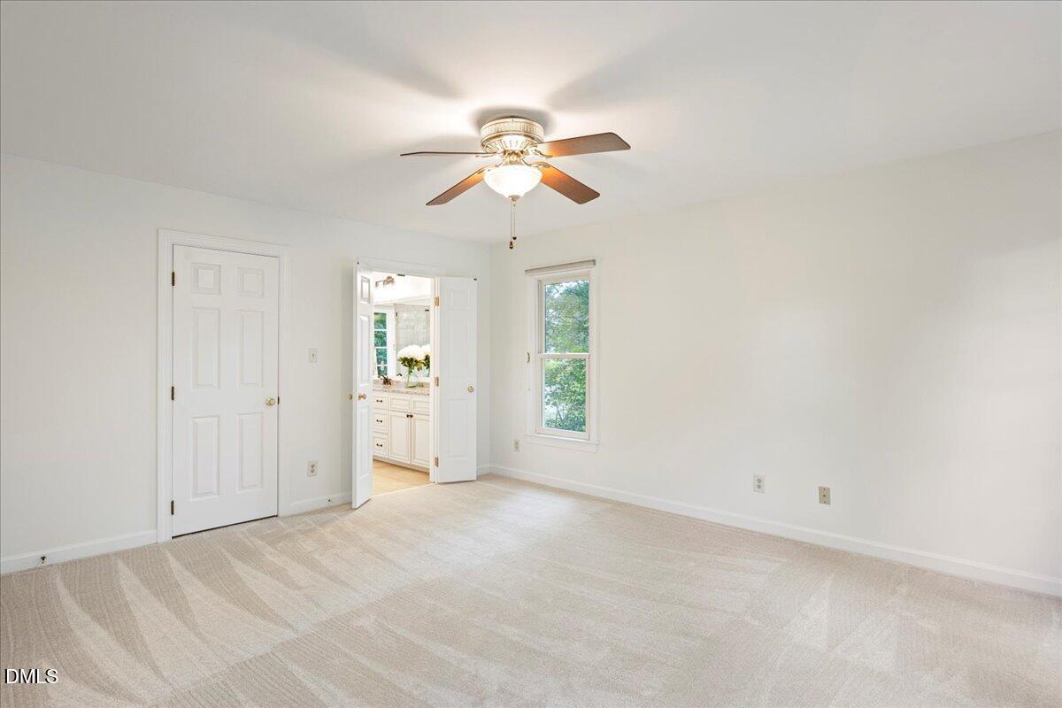 7029 Spring Ridge Road Cary, NC 27518 - Photo 18 of 39 Tucked away in private corner on second floor is the primary bedroom.