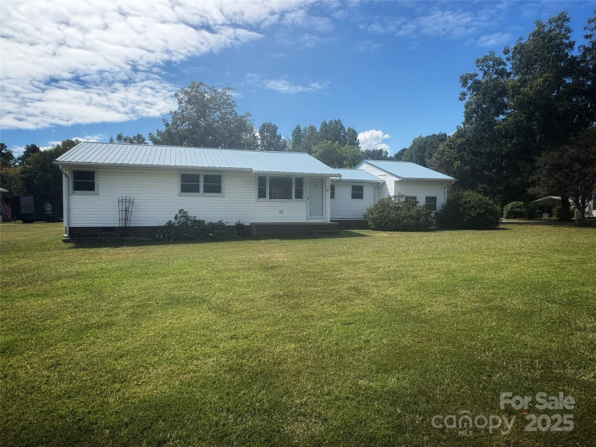 335 Plank Road Wadesboro, NC 28170 - Photo 1 of 14 a view of a house with a yard