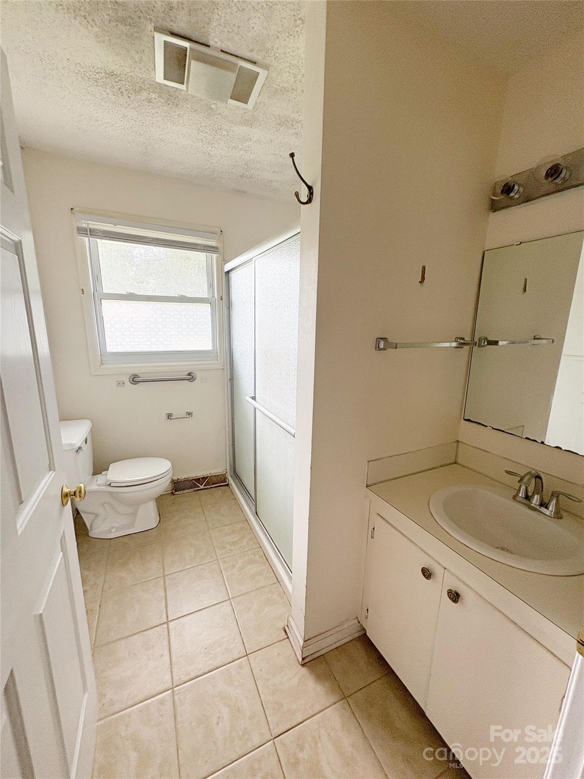 335 Plank Road Wadesboro, NC 28170 - Photo 13 of 14 a bathroom with a granite countertop sink a toilet and a mirror