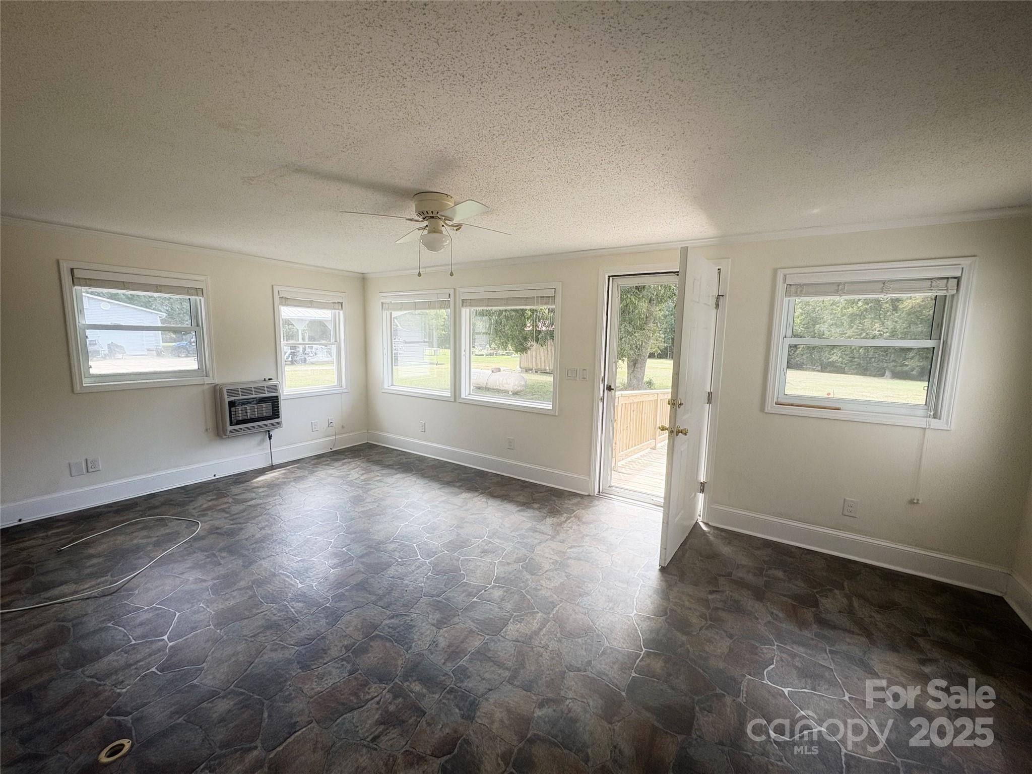 335 Plank Road Wadesboro, NC 28170 - Photo 3 of 14 a view of an empty room with a window and wooden floor