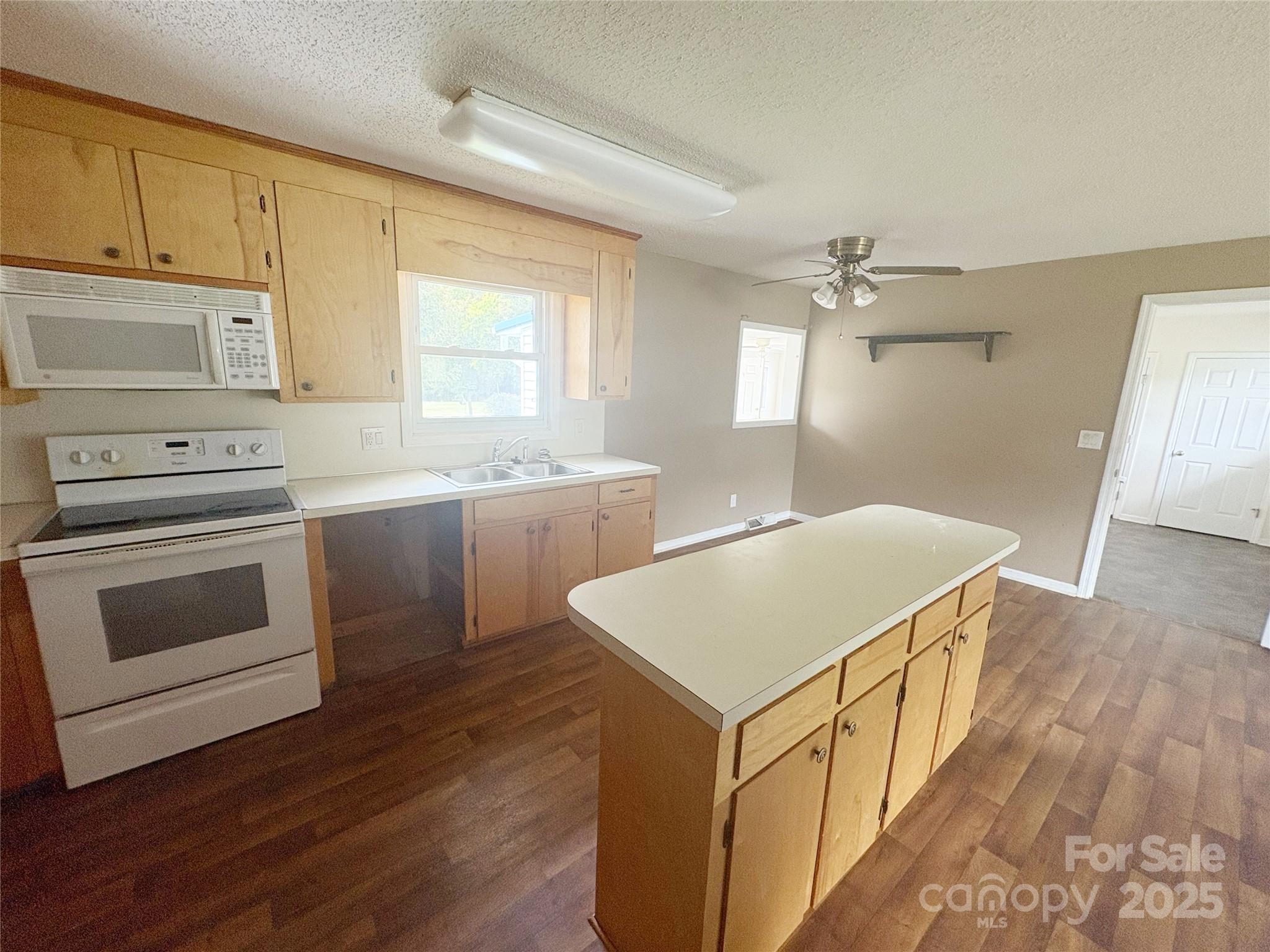 335 Plank Road Wadesboro, NC 28170 - Photo 8 of 14 a kitchen with a stove a sink and a refrigerator