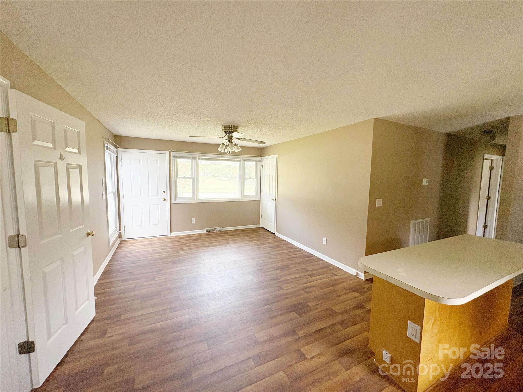 335 Plank Road Wadesboro, NC 28170 - Photo 9 of 14 a view of empty room with wooden floor and fan