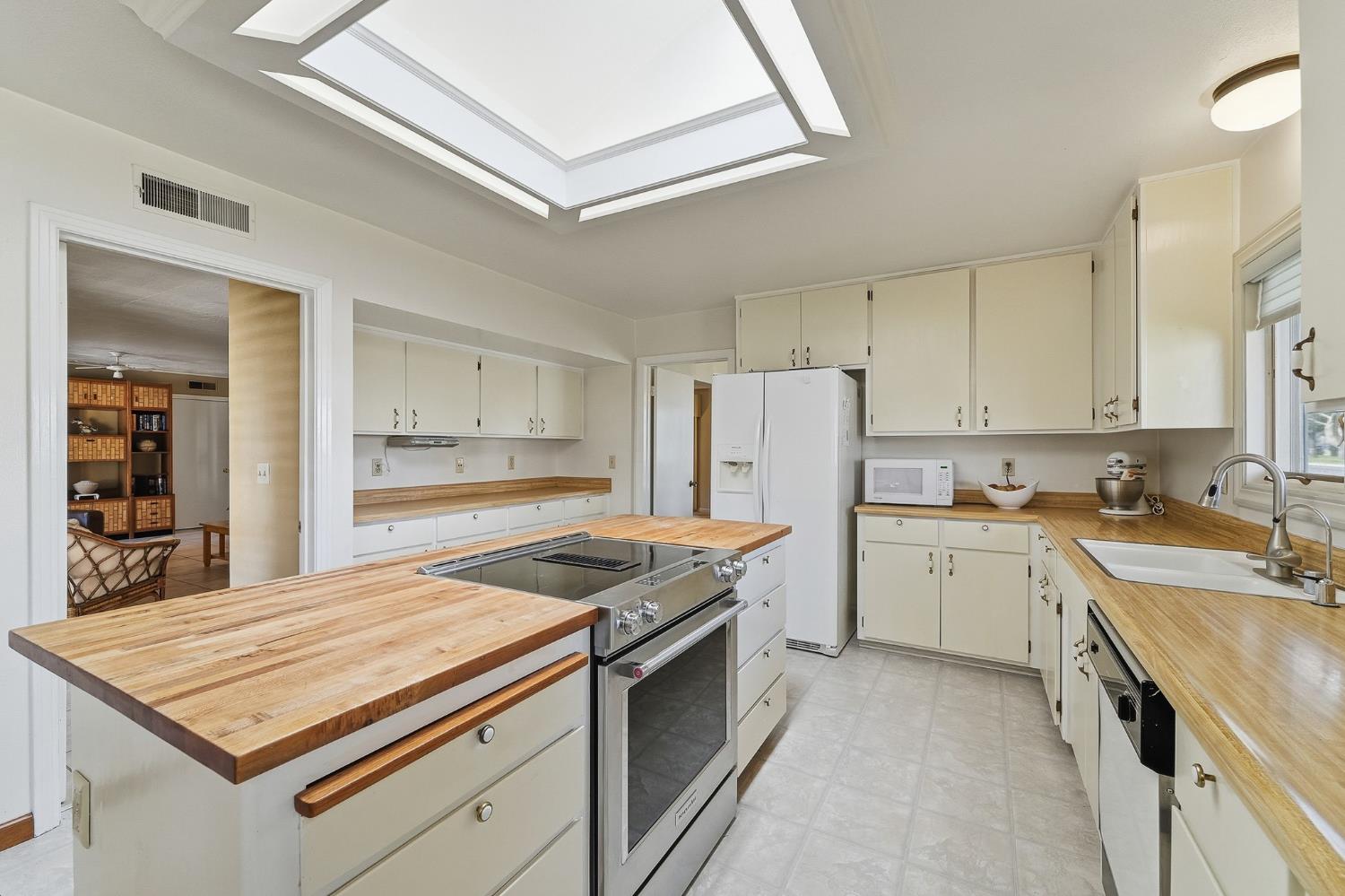 1344 Magnolia Avenue Modesto, CA 95350 - Photo 15 of 71 a kitchen with a stove a sink and a refrigerator