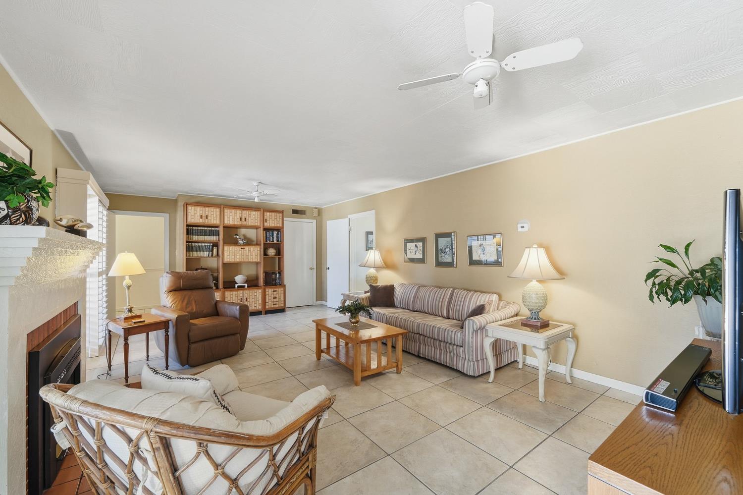 1344 Magnolia Avenue Modesto, CA 95350 - Photo 24 of 71 a living room with furniture a fireplace and a flat screen tv