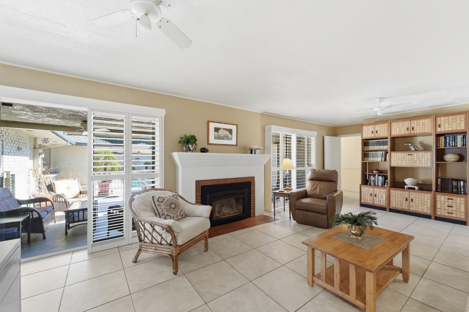1344 Magnolia Avenue Modesto, CA 95350 - Photo 25 of 71 a living room with furniture a flat screen tv and a fireplace