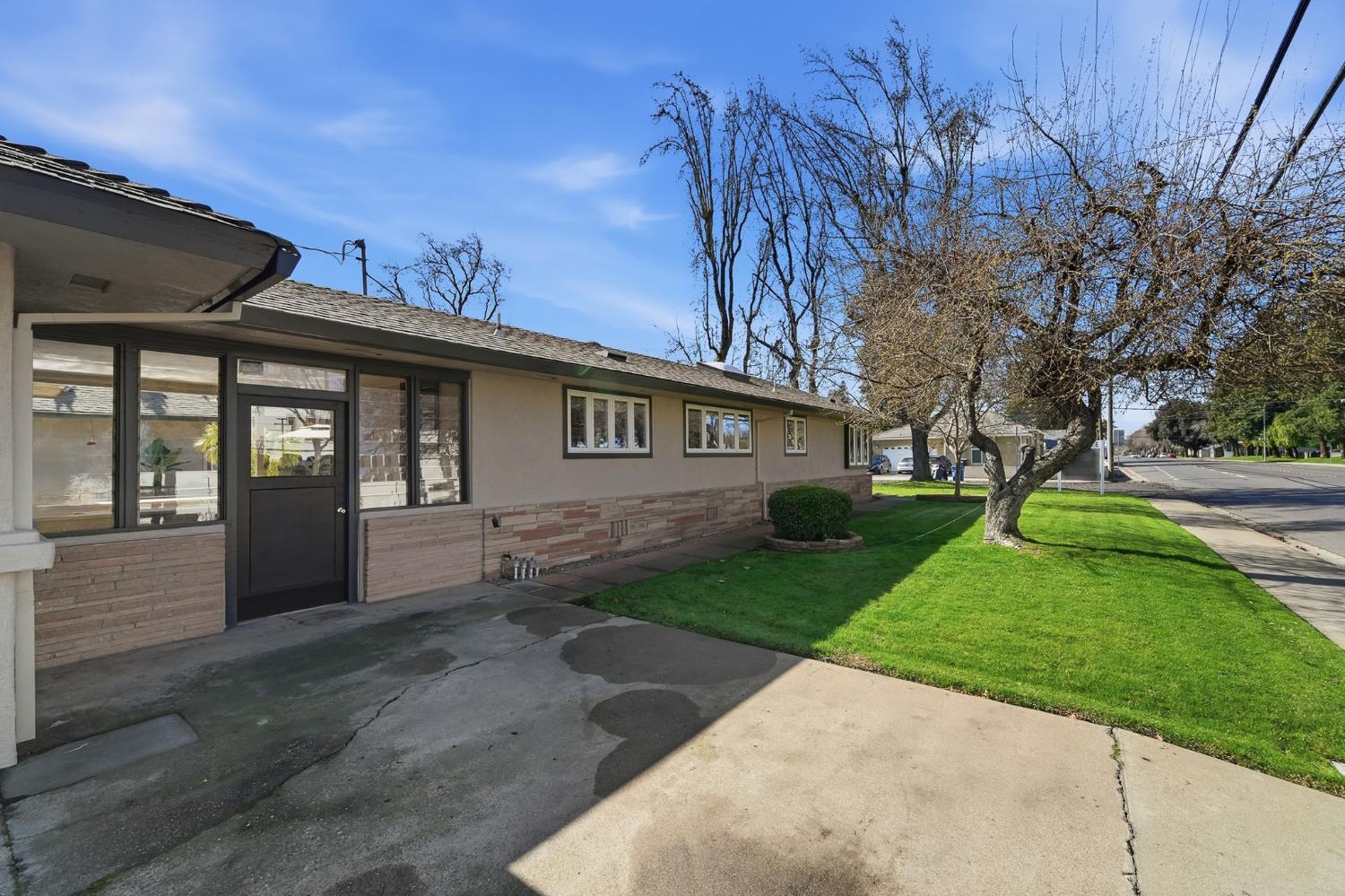 1344 Magnolia Avenue Modesto, CA 95350 - Photo 43 of 71 a front view of a house with a garden and yard