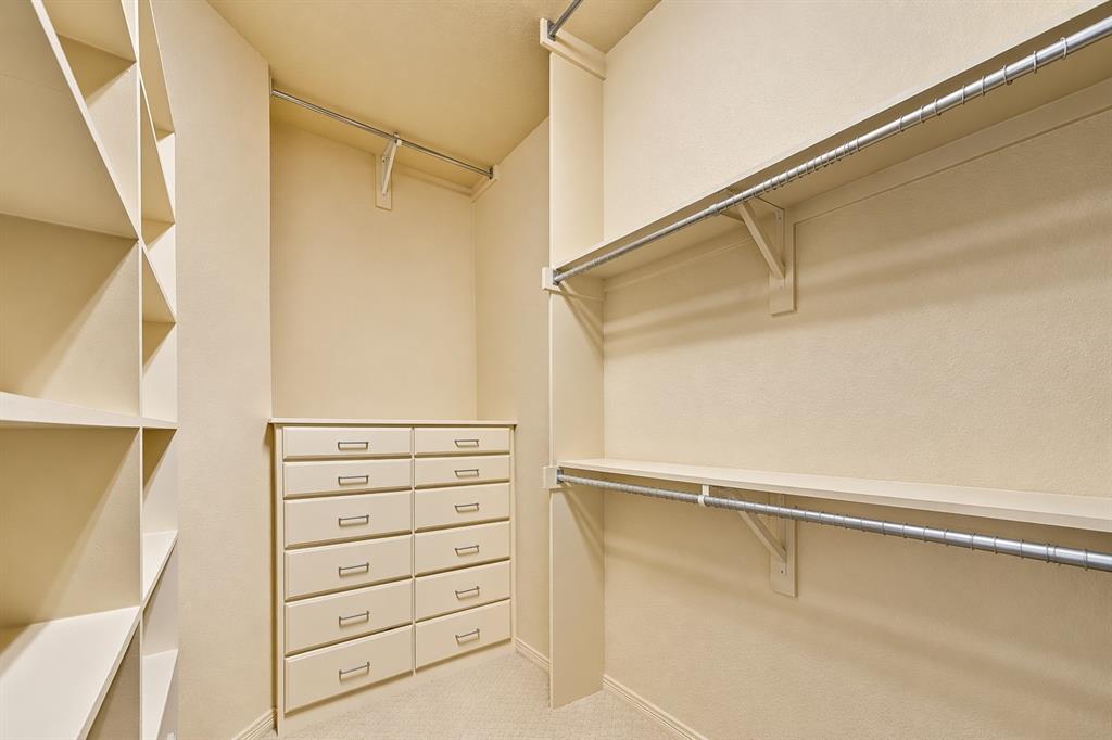 1520 Snider Court Lucas, TX 75002 - Photo 24 of 40 This secondary primary suite, or MIL suite, has a walk-in closet with built-in shelving, drawers, and hanging rods. Tons of storage in this custom home!
