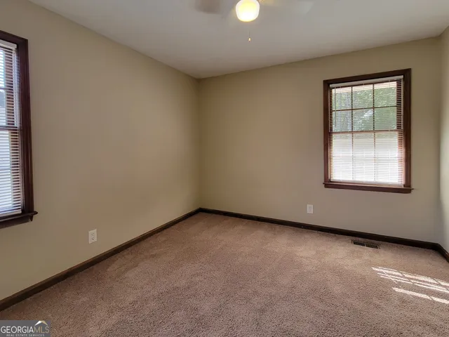 a view of a field with trees in the background