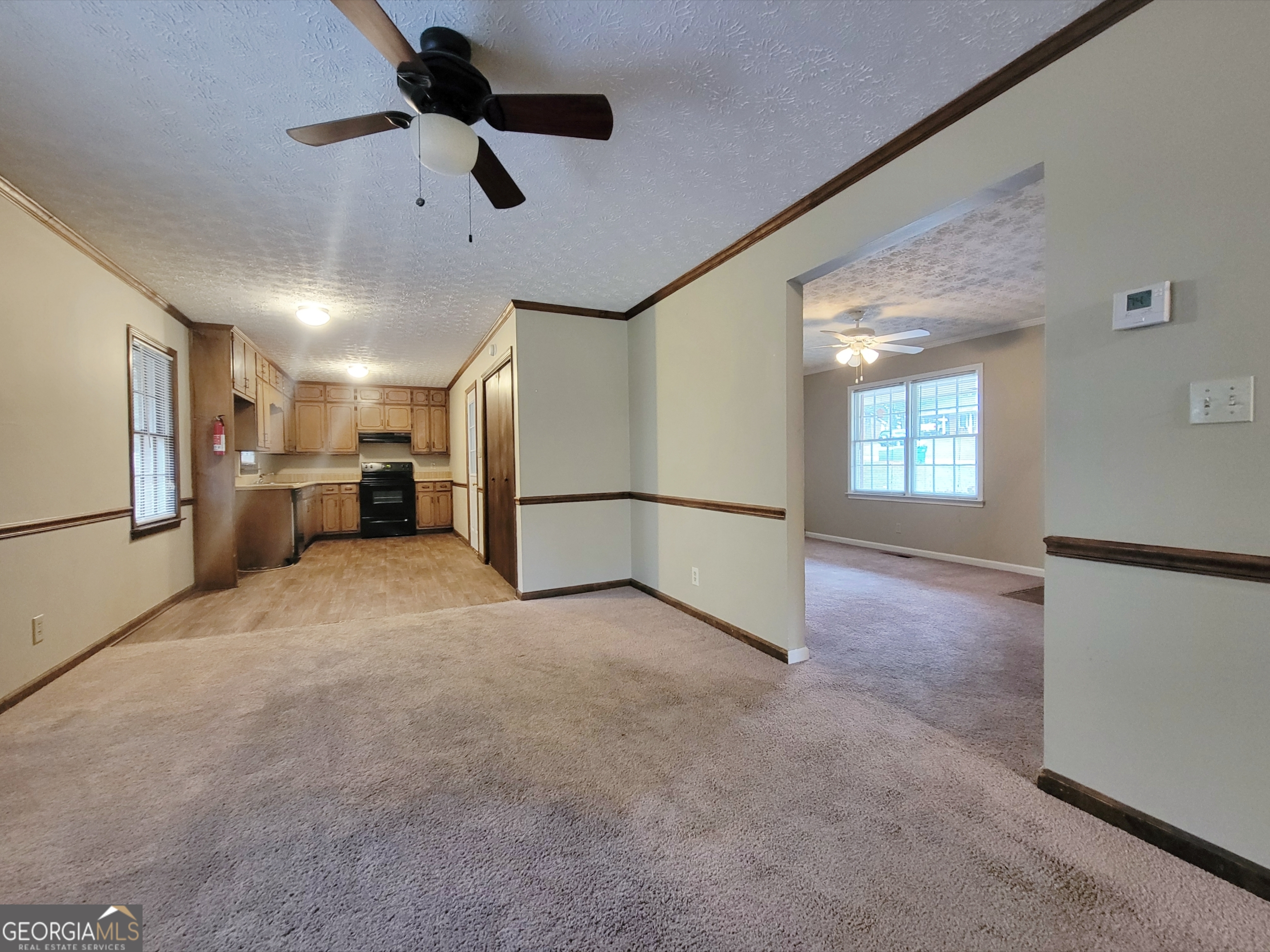 133 Plantation Road Winder, GA 30680 - Photo 4 of 13 a view of a kitchen with a sink and refrigerator
