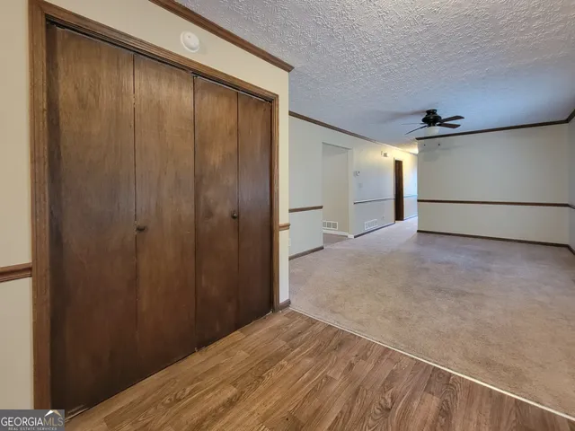 a kitchen with granite countertop wooden cabinets and a stove top oven