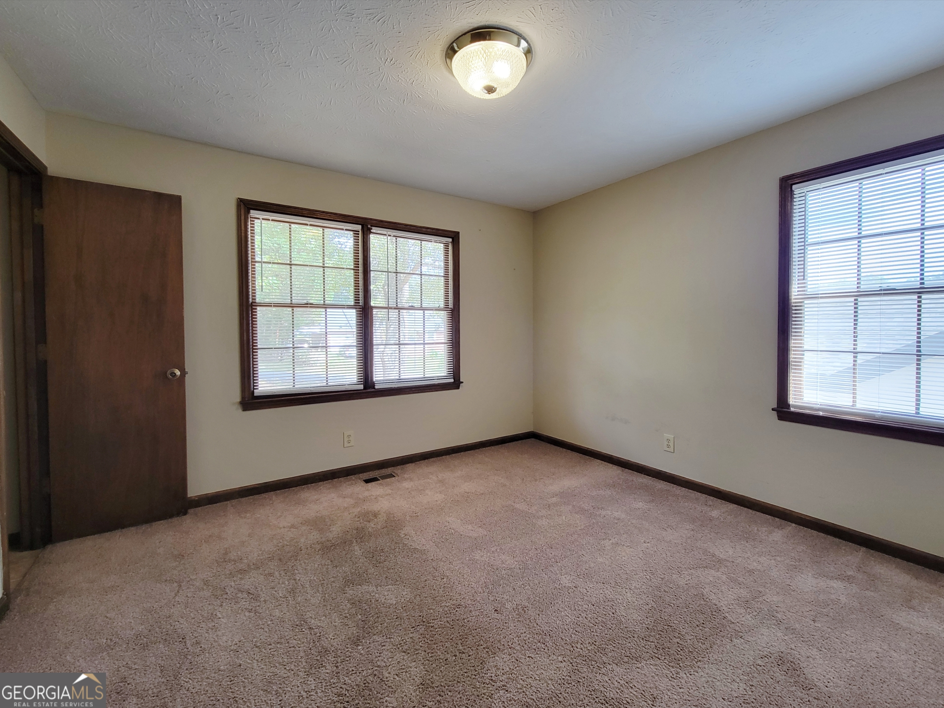 133 Plantation Road Winder, GA 30680 - Photo 10 of 13 an empty room with windows