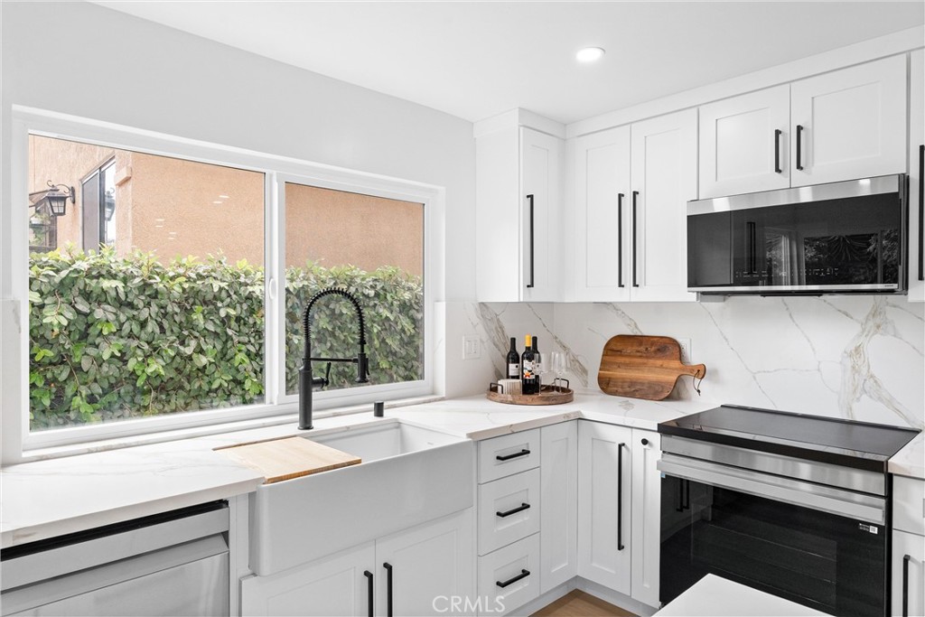3621 Myrtle Street Irvine, CA 92606 - Photo 11 of 40 a kitchen with a sink a stove and cabinets