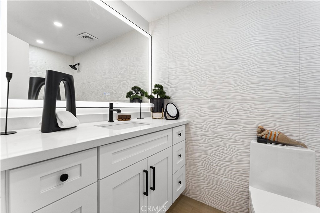 3621 Myrtle Street Irvine, CA 92606 - Photo 22 of 40 a bathroom with a sink and a mirror