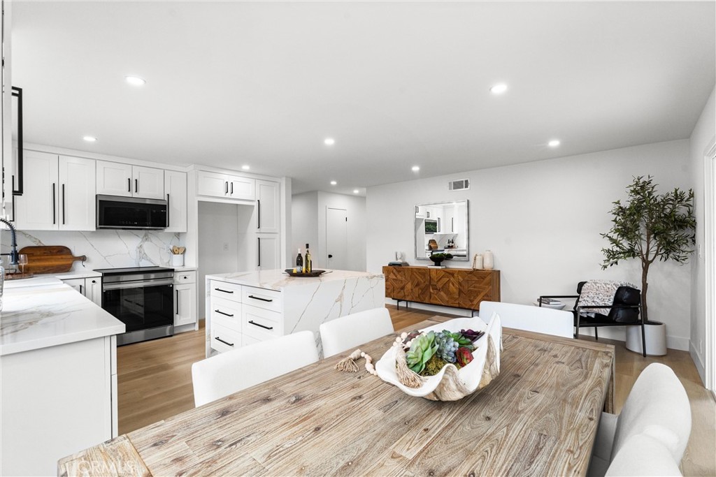 3621 Myrtle Street Irvine, CA 92606 - Photo 10 of 40 a living room with stainless steel appliances furniture wooden floor and a kitchen view