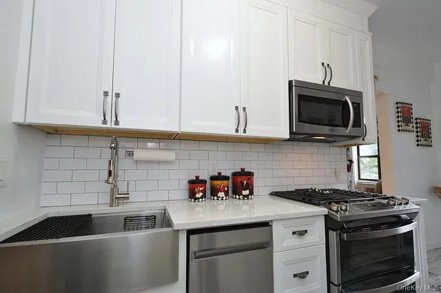 a kitchen with cabinets appliances and a window