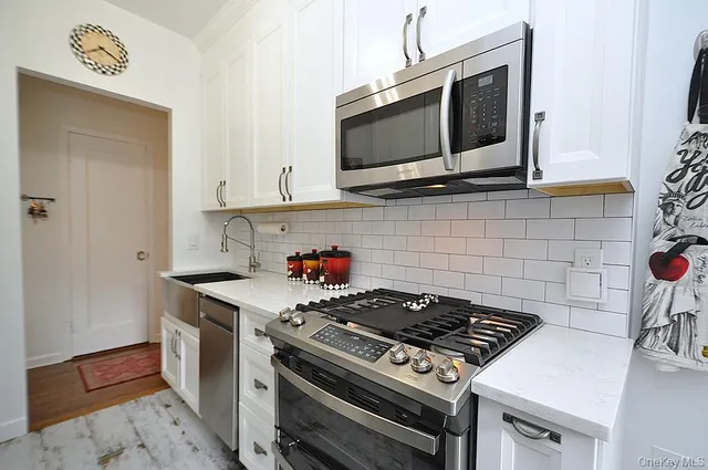 a kitchen with a sink appliances and cabinets