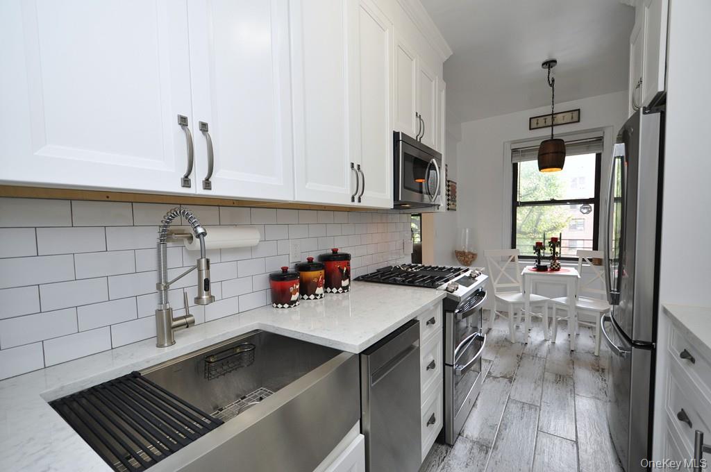 143 Garth Road, Unit 3L Scarsdale, NY 10583 - Photo 15 of 50 a kitchen with a sink appliances and cabinets