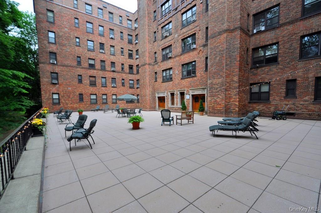 143 Garth Road, Unit 3L Scarsdale, NY 10583 - Photo 38 of 50 a wooden bench sitting in front of building