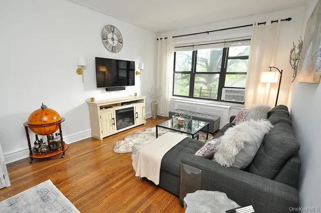 a living room with furniture and a book shelf