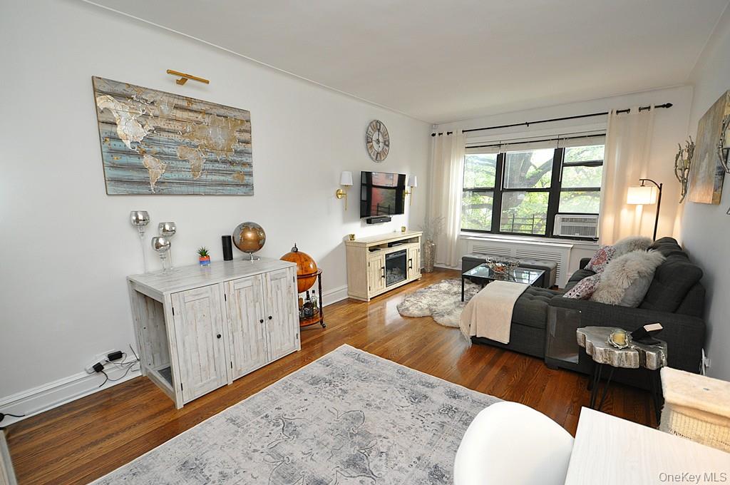 143 Garth Road, Unit 3L Scarsdale, NY 10583 - Photo 7 of 50 a living room with furniture and a flat screen tv