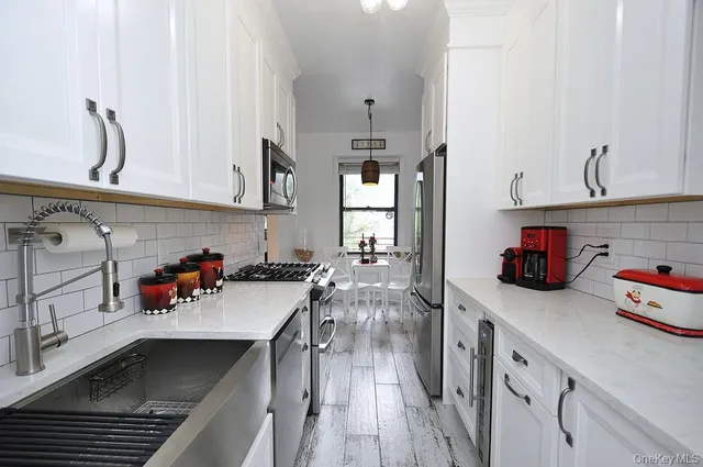 a kitchen with stainless steel appliances granite countertop a sink and a stove
