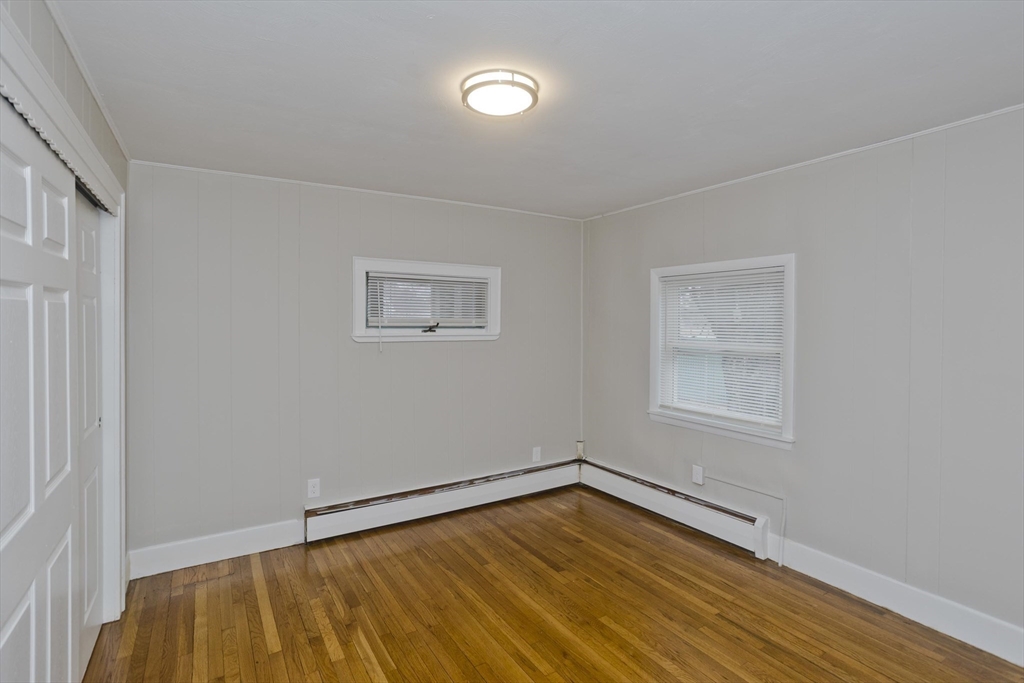 177 Marion Street Chicopee, MA 01013 - Photo 13 of 36 a view of an empty room with wooden floor and a window