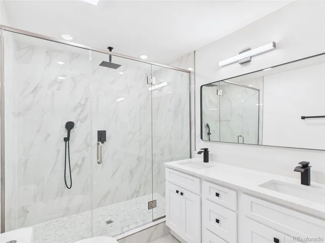 a bathroom with a shower sink and mirror