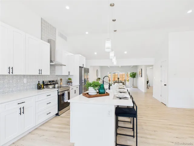 a kitchen with stainless steel appliances kitchen island granite countertop a sink and cabinets