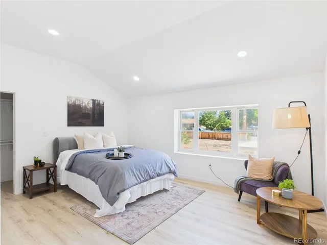 a living room with a bed furniture and a window
