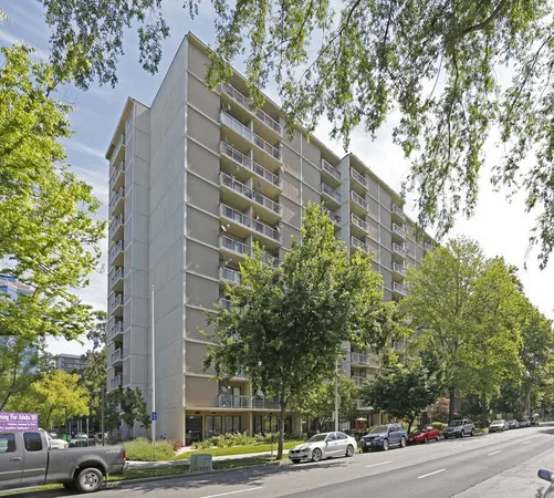 a view of a tall building next to a road