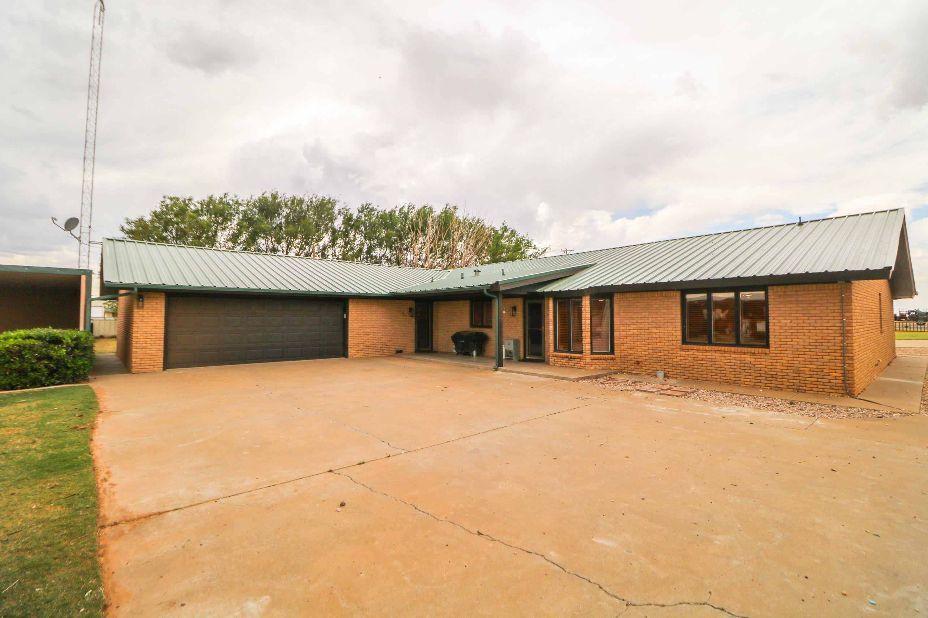 1740 Highway 70 Springlake, TX 79082 - Photo 23 of 39 a front view of a house with a yard and garage