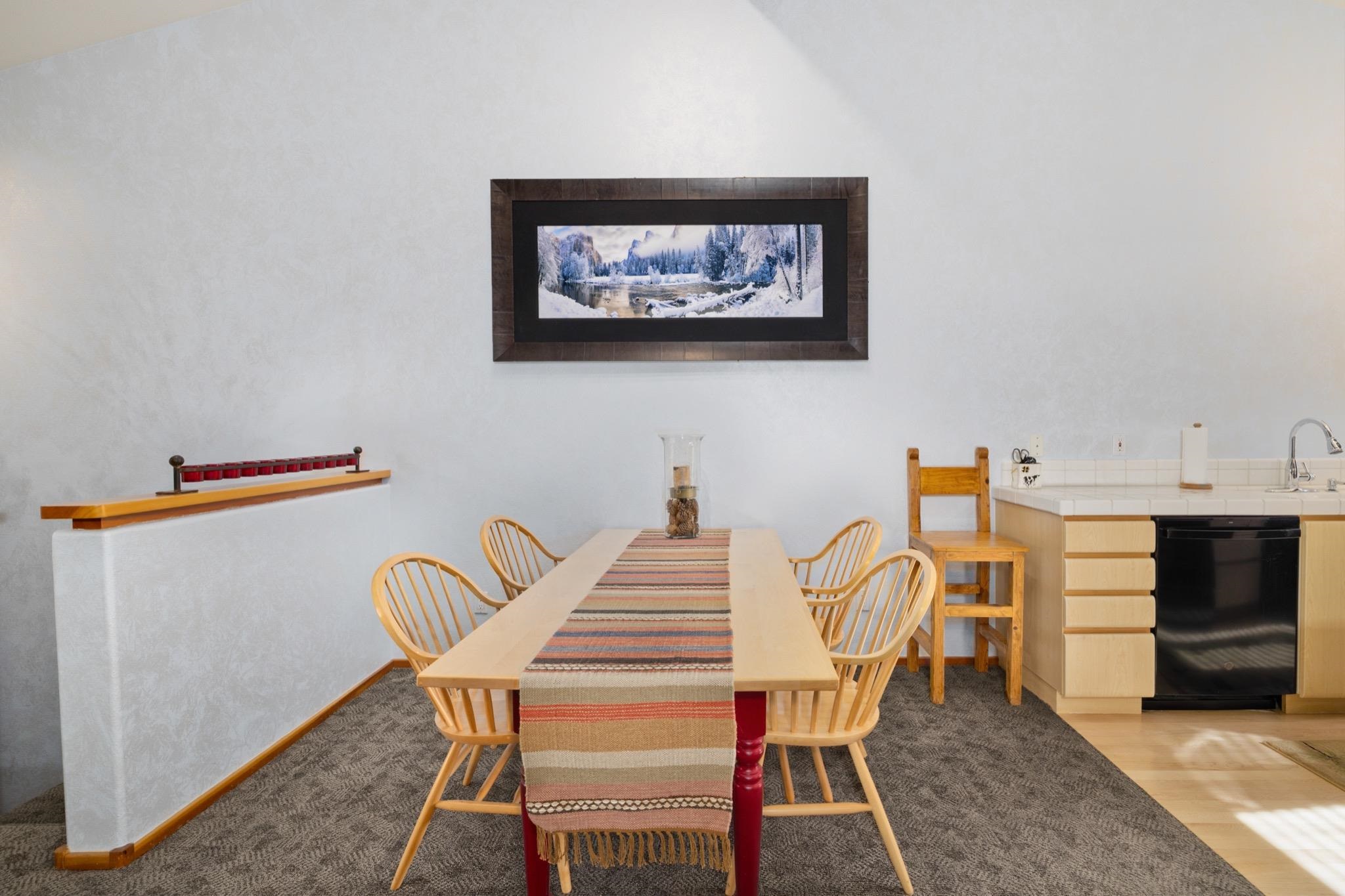 930 Links Way, Unit 930 Mammoth Lakes, CA 93546 - Photo 13 of 40 a view of a dining room with furniture and wooden floor