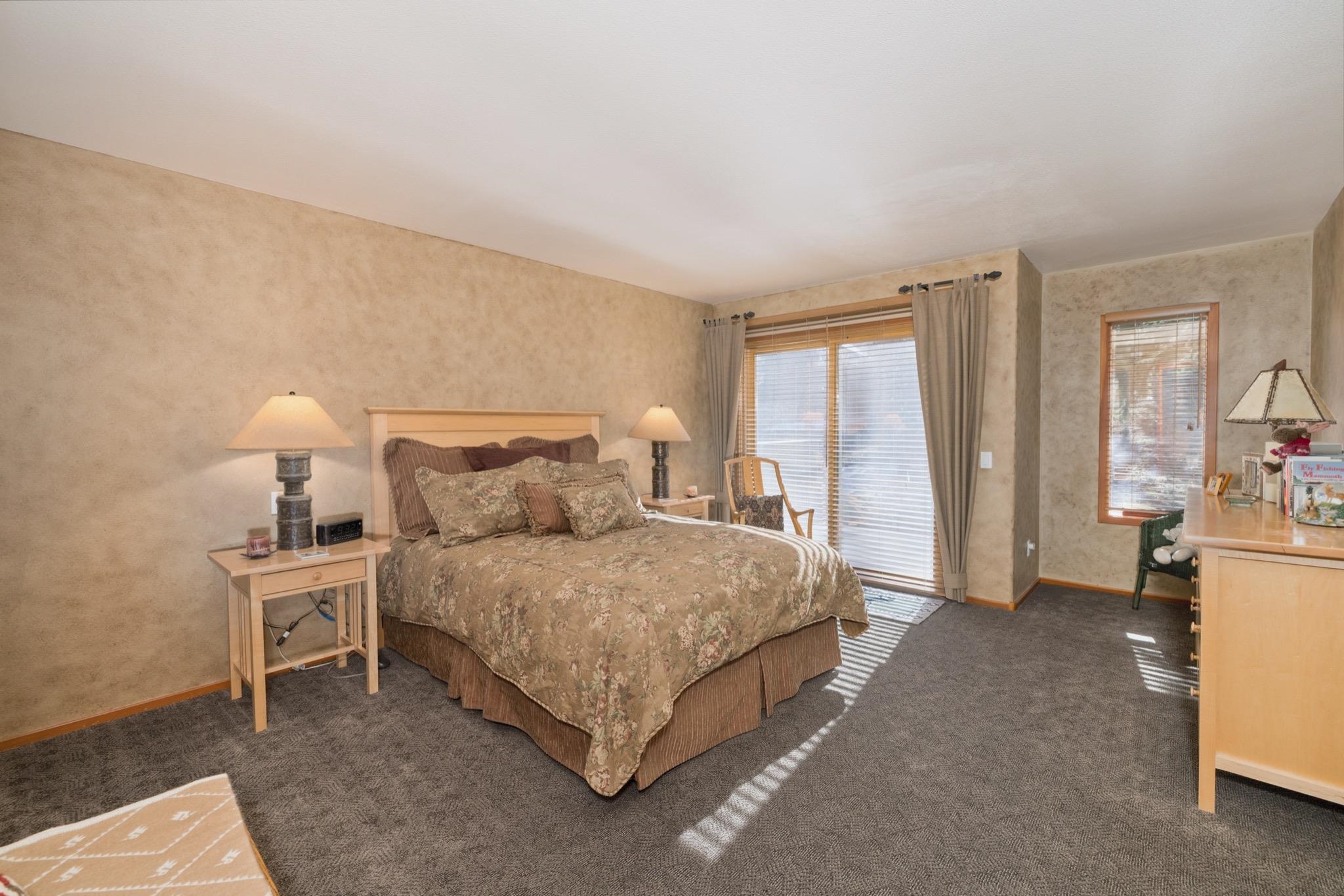 930 Links Way, Unit 930 Mammoth Lakes, CA 93546 - Photo 24 of 40 a spacious bedroom with a bed and large windows