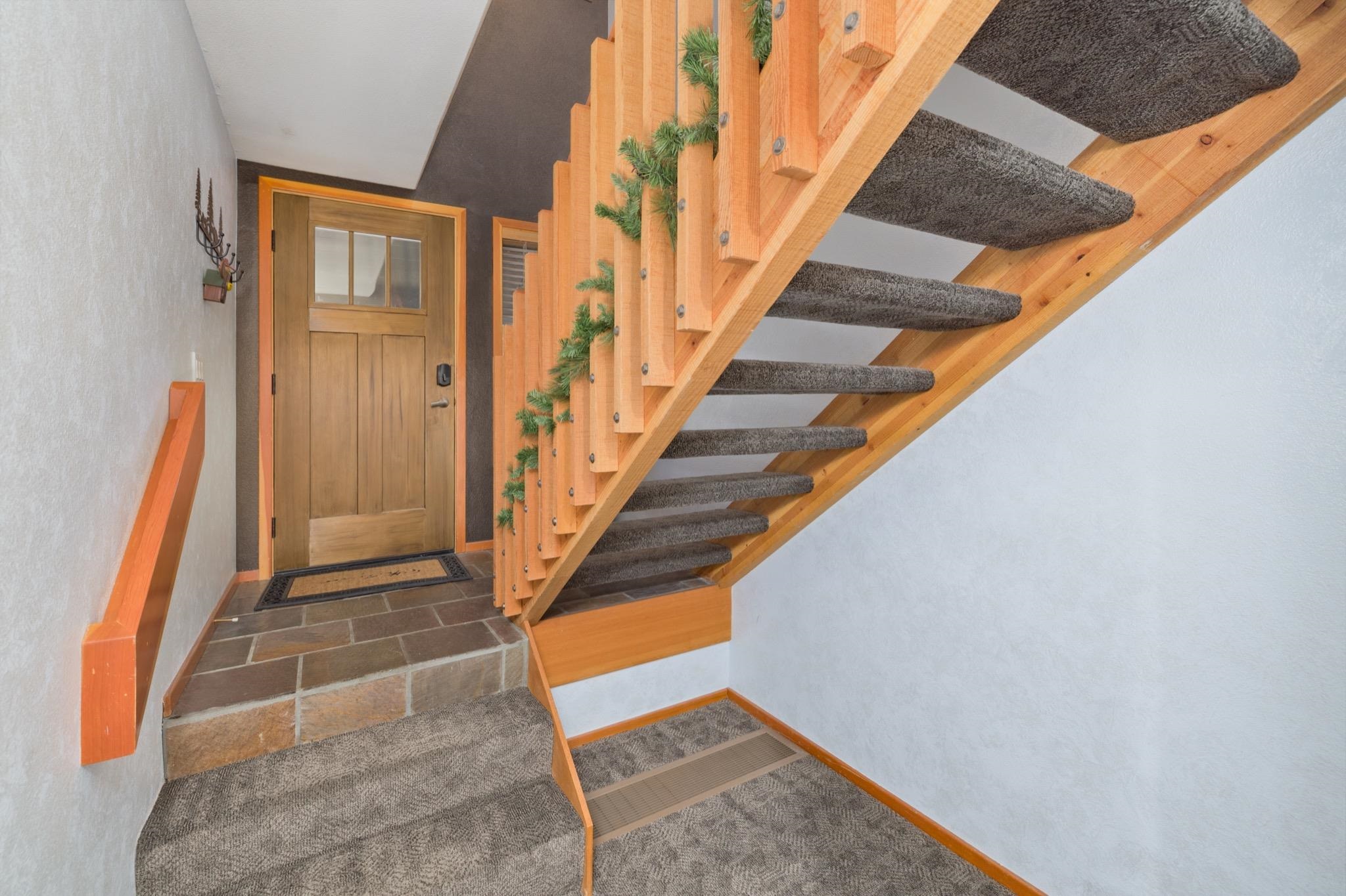 930 Links Way, Unit 930 Mammoth Lakes, CA 93546 - Photo 5 of 40 a view of staircase with wooden floor and a rug