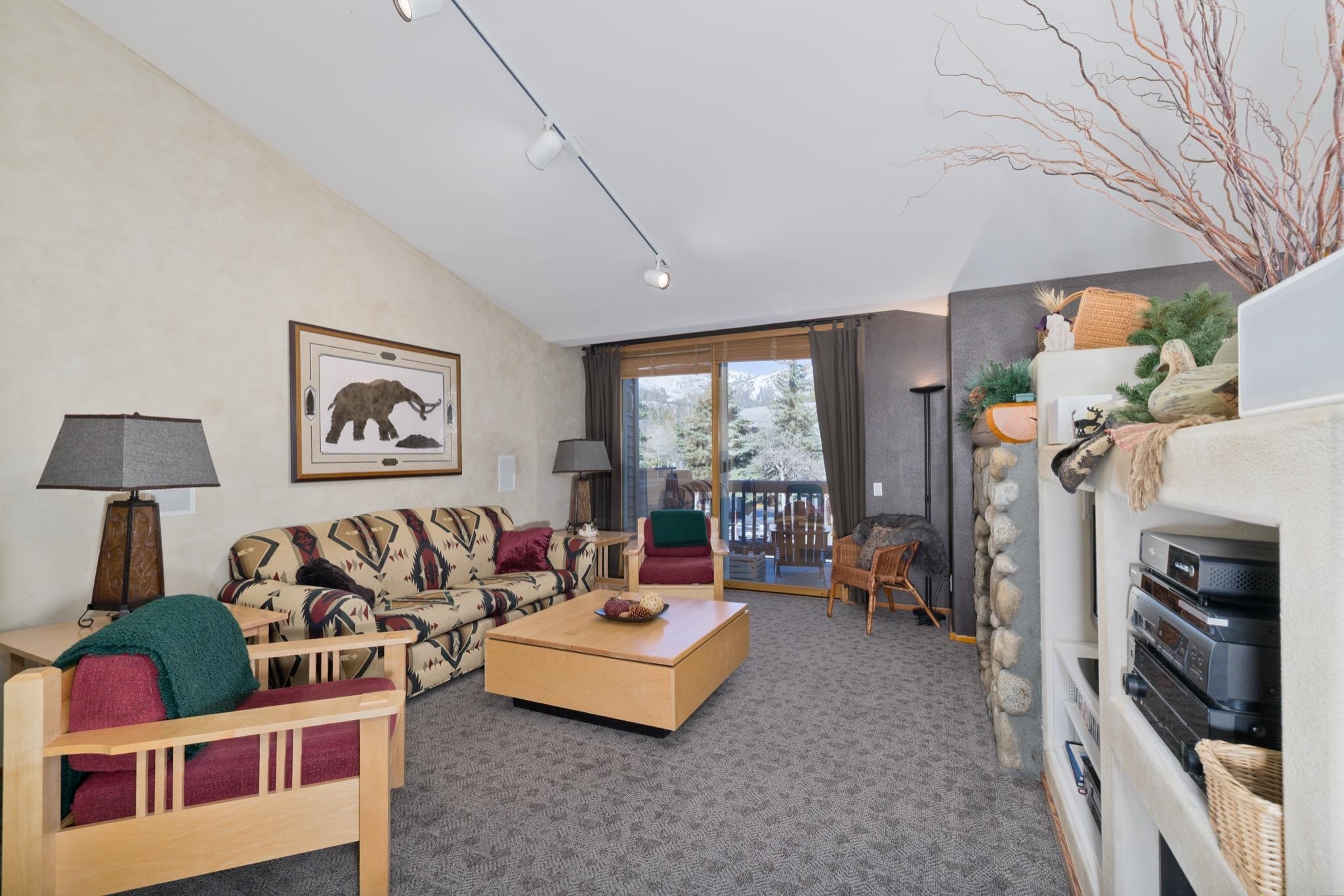 930 Links Way, Unit 930 Mammoth Lakes, CA 93546 - Photo 6 of 40 a living room with furniture and a flat screen tv