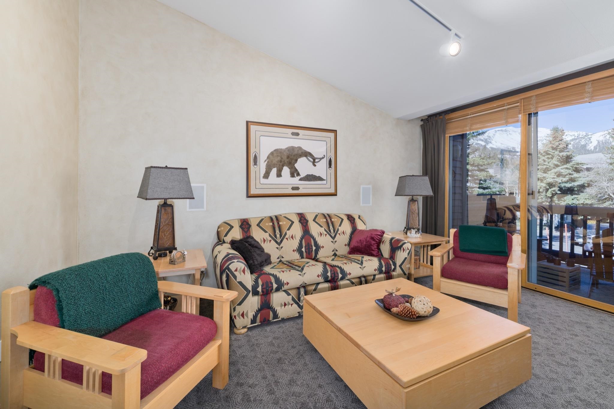 930 Links Way, Unit 930 Mammoth Lakes, CA 93546 - Photo 8 of 40 a living room with furniture and a floor to ceiling window