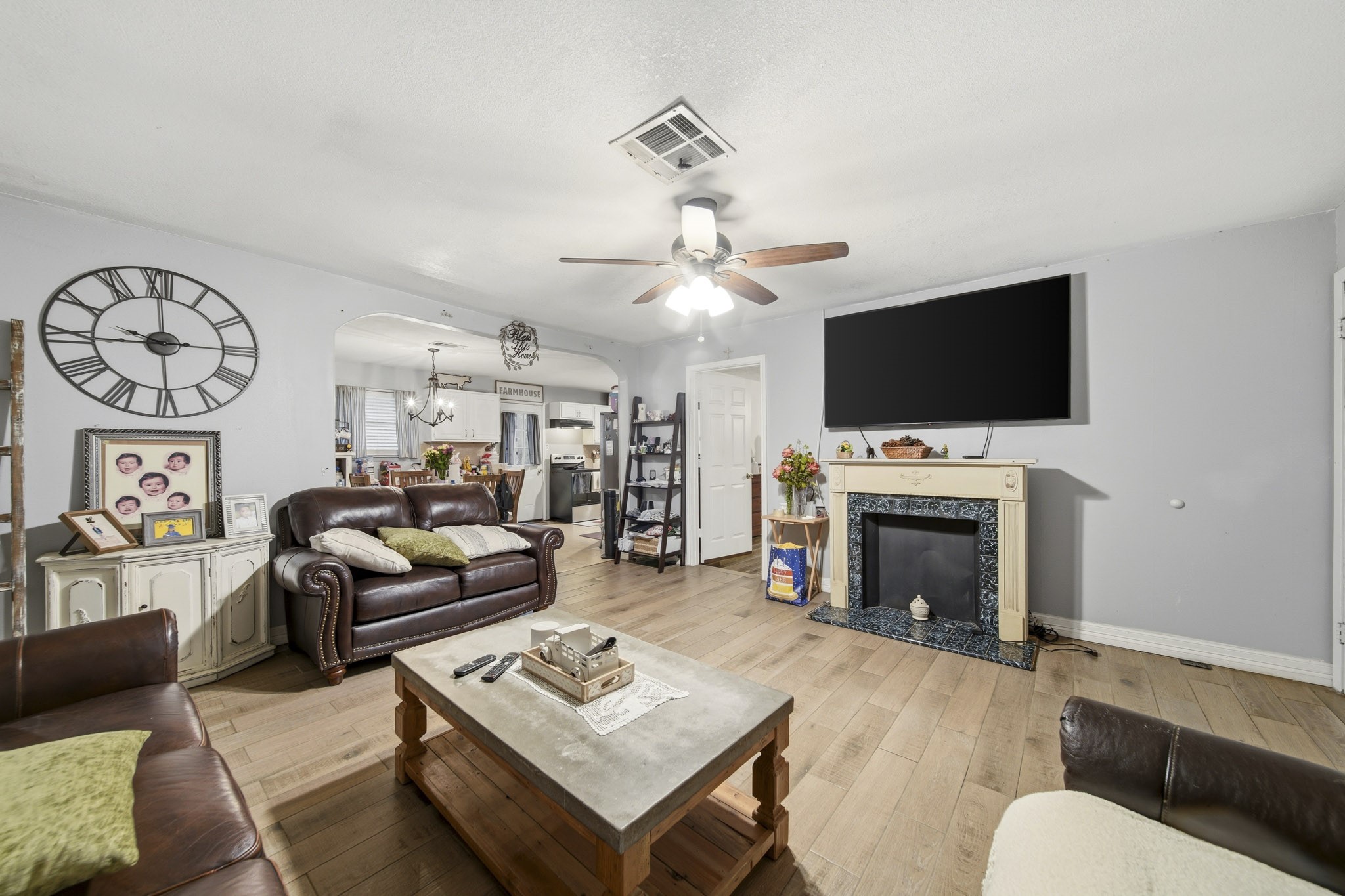 731 Meneley Road Winnie, TX 77665 - Photo 5 of 27 a living room with furniture a flat screen tv and a fireplace