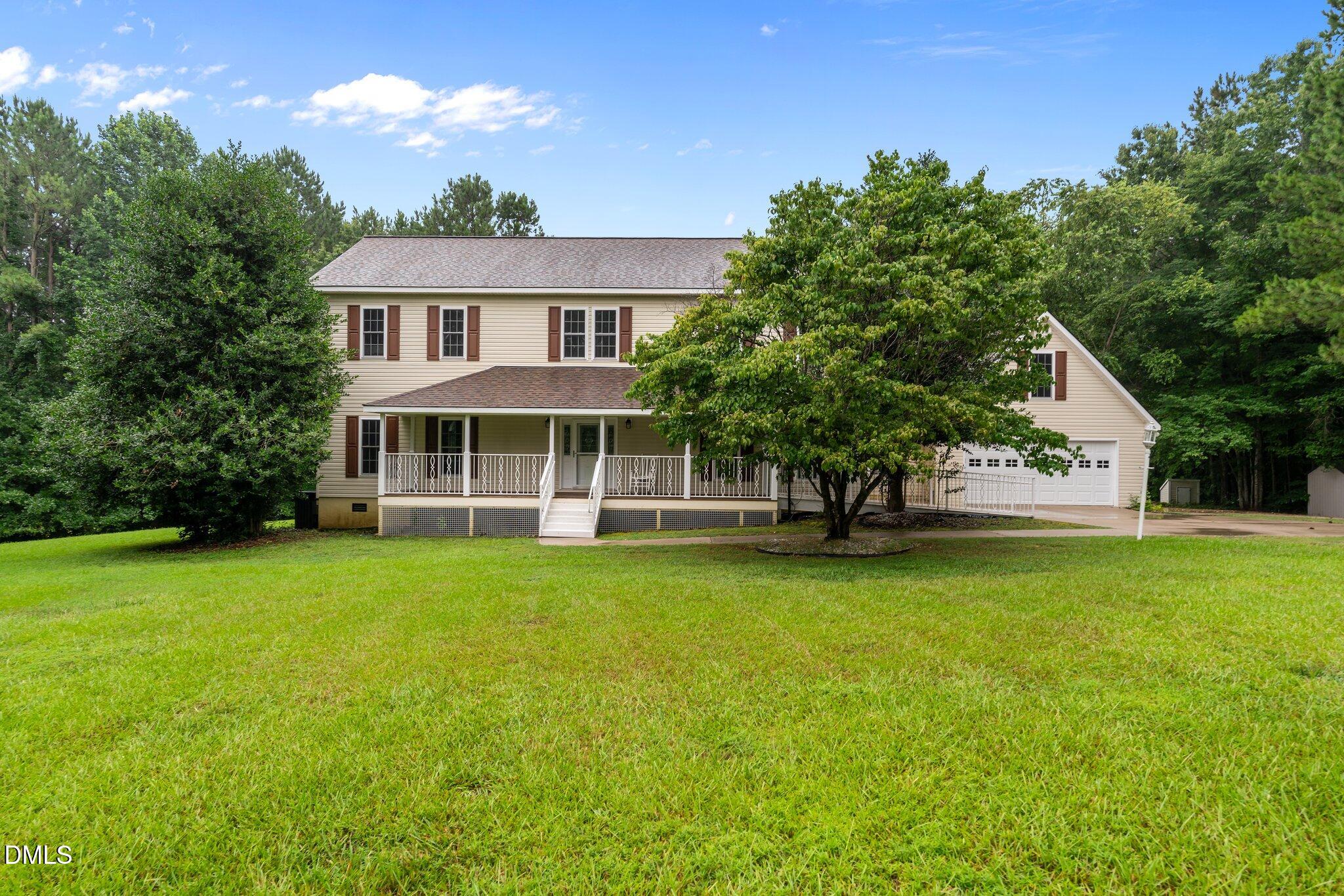 431 Patterson Ridge Lane Sanford, NC 27330 - Photo 1 of 29 a front view of a house with a garden