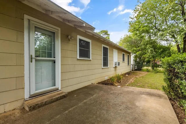 a front view of a house with yard and green space
