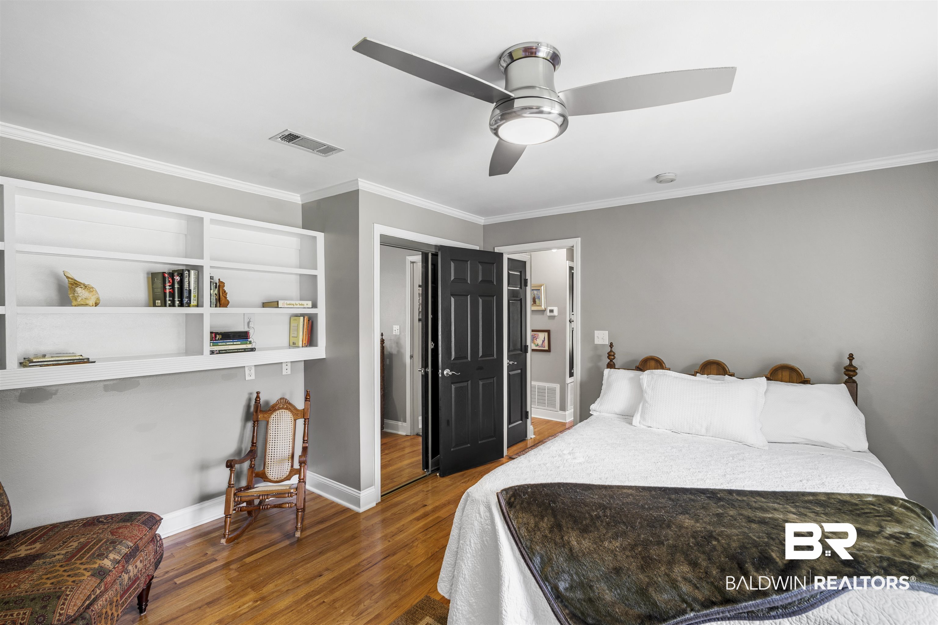 1615 5th Street Daphne, AL 36526 - Photo 18 of 28 Bedroom featuring wood-finish flooring, built-in shelving, crown molding, and a contemporary ceiling fan with integrated lighting